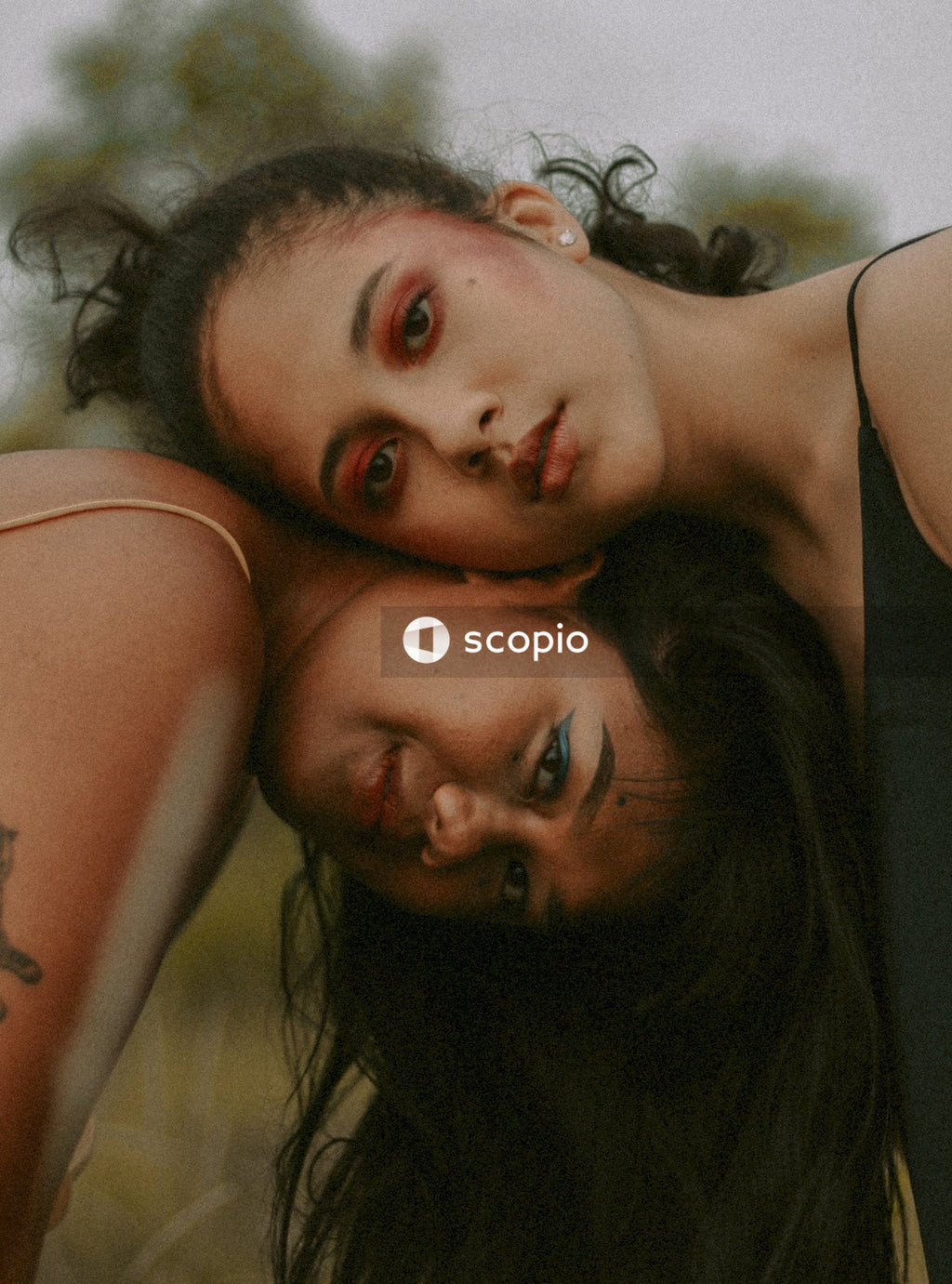 Two women leaning their heads on top of each other