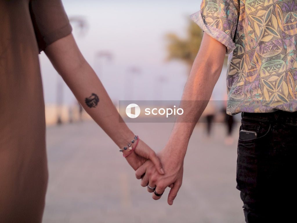 Couple holding hands on a boardwalk