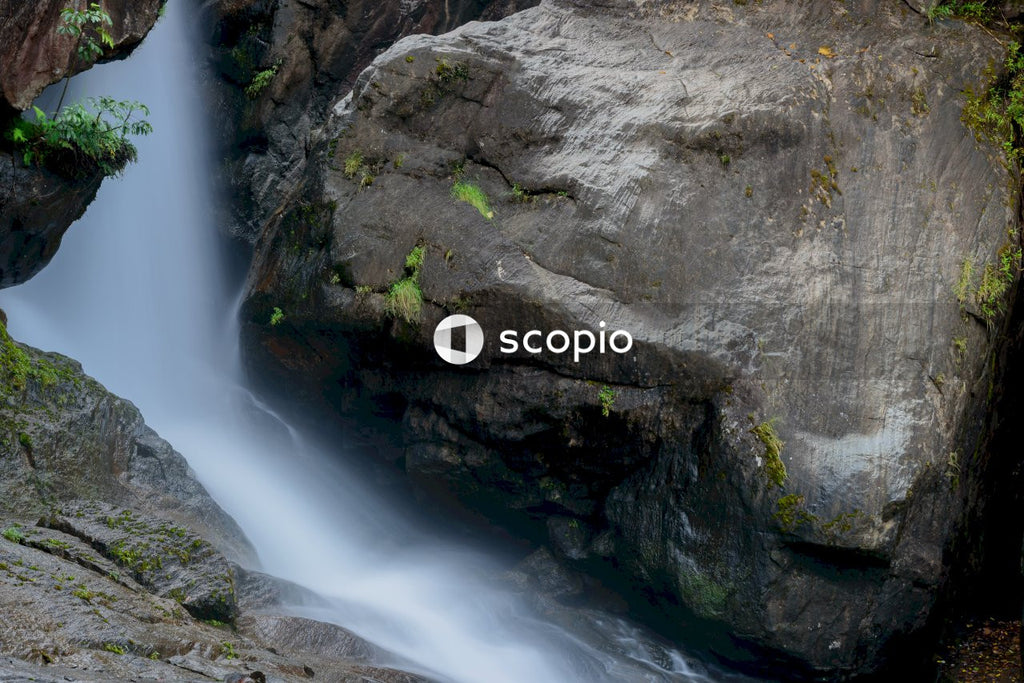 Water falls between gray rocks