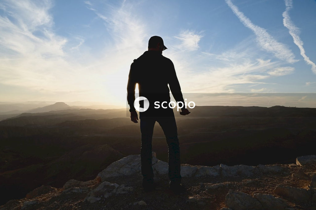 Man in black jacket standing on rock