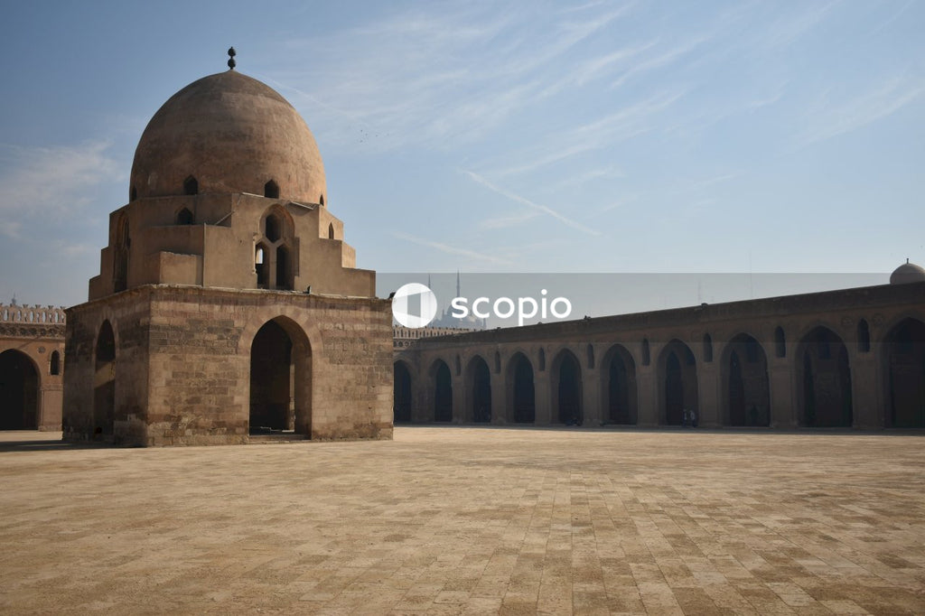 Brown concrete dome building under blue sky