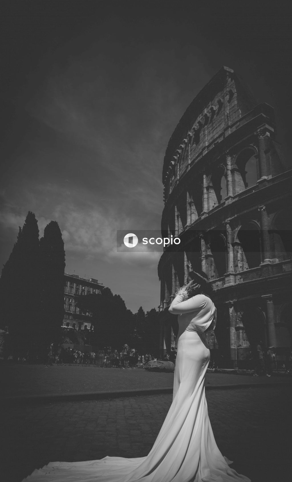 Bride in Stunning White Dress Poses in Front of Ancient Colosseum