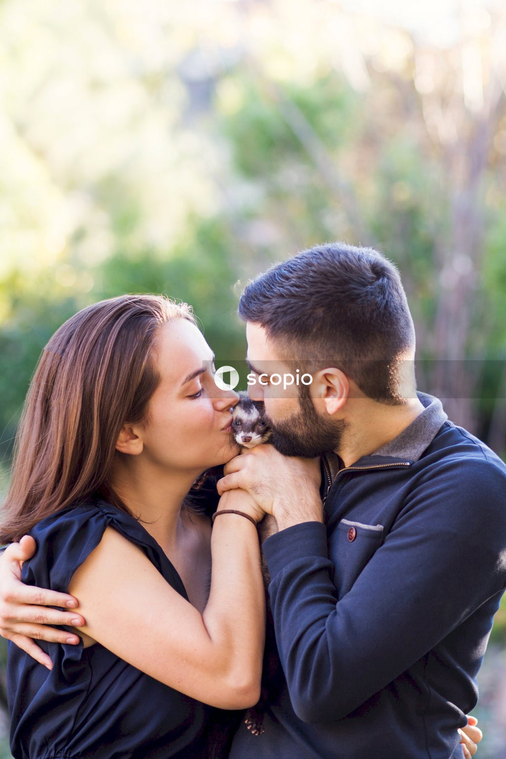 Couple kissing an animal