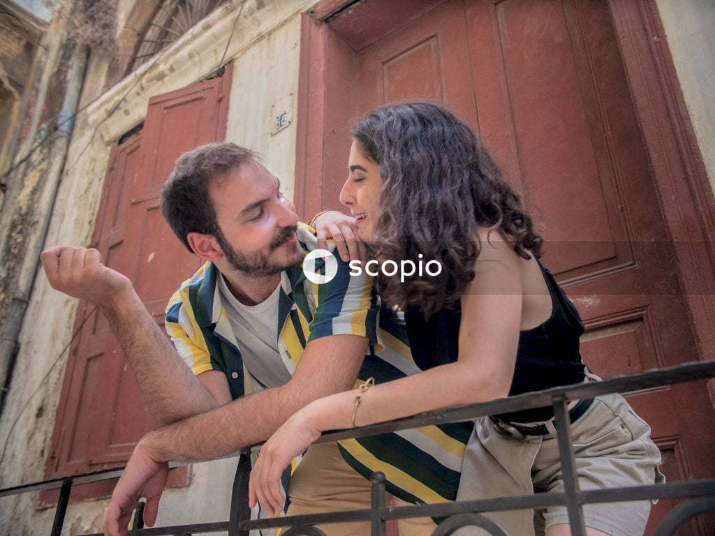 Woman and man leaning on rail and intimately talking