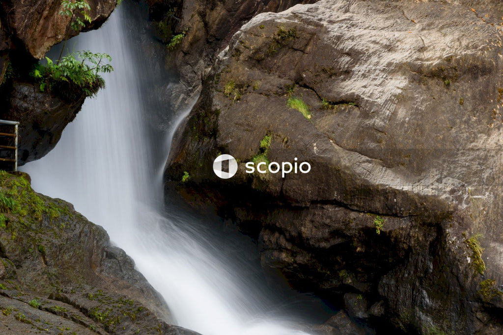Water falls on brown rock