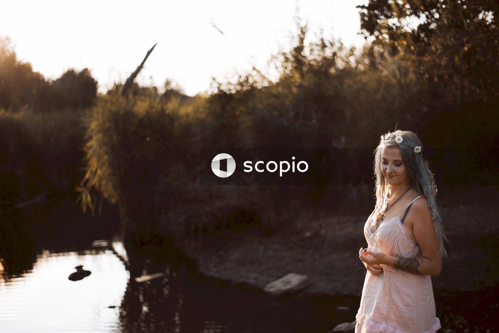 Woman in white dress standing near river