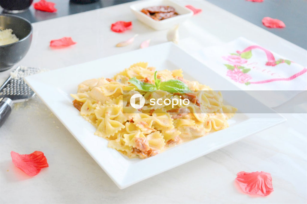 Yellow and green pasta on white ceramic plate