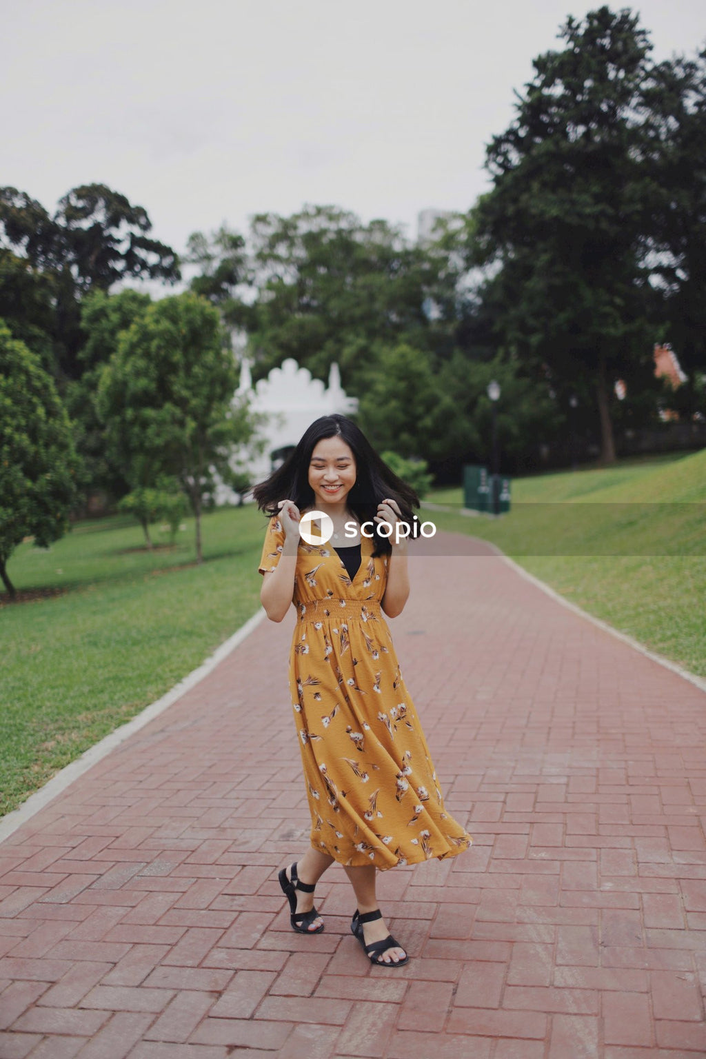 Woman wearing long orange dress standing in nature