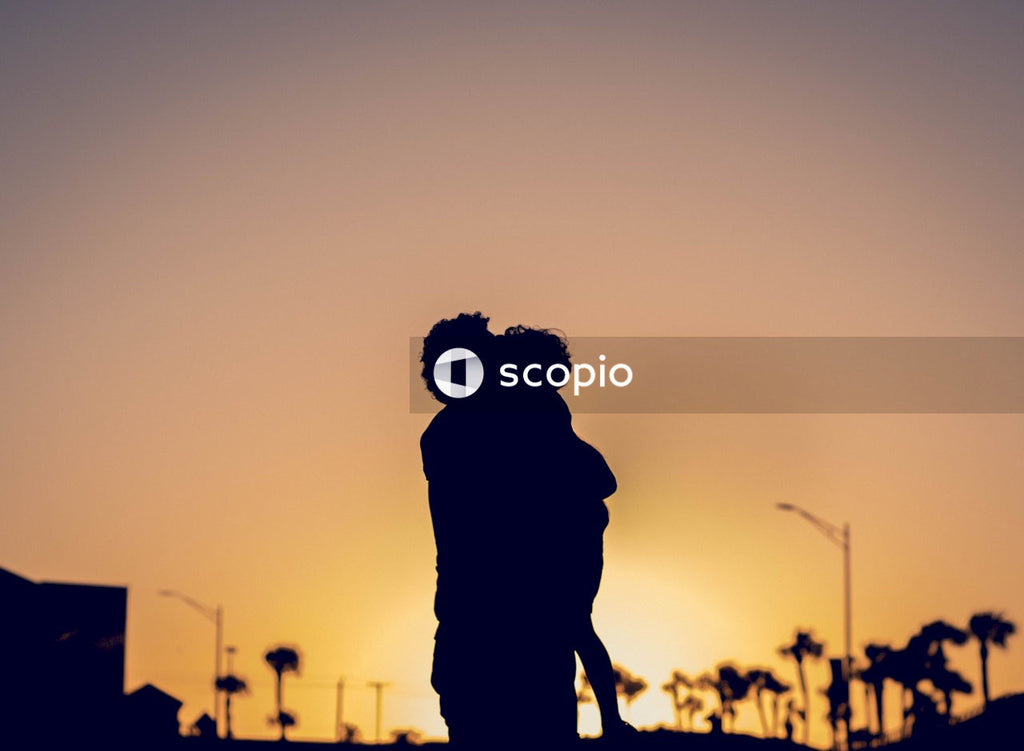 Father and Son Shares Hug Under Palm Trees and Sunset