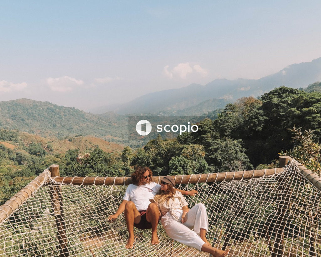 Couple relaxing on net in mountains