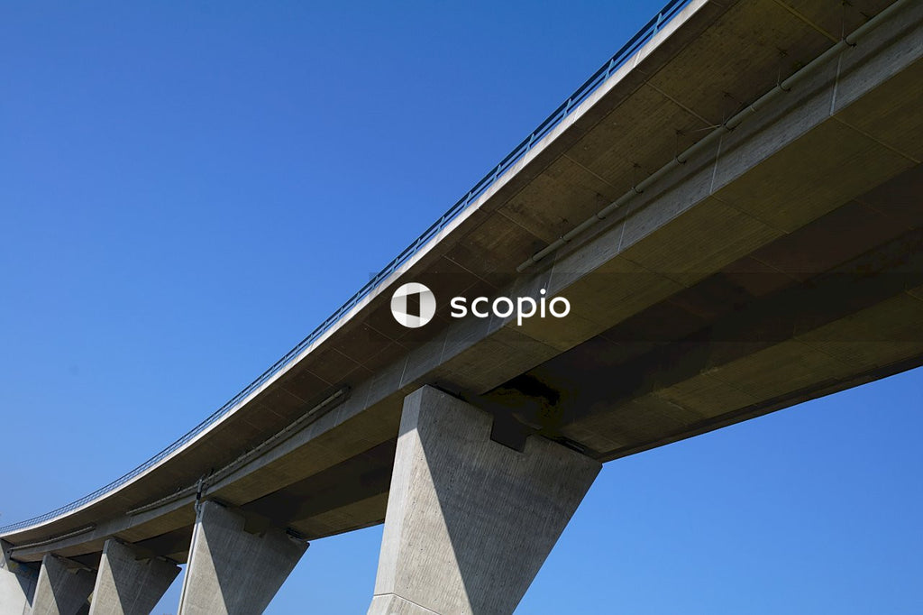 White concrete bridge under blue sky