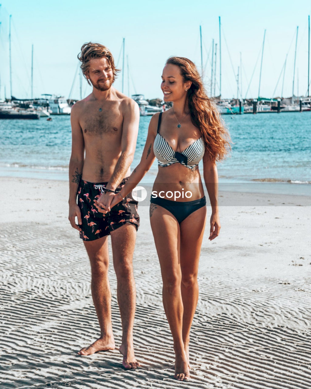 Man and woman standing on seashore