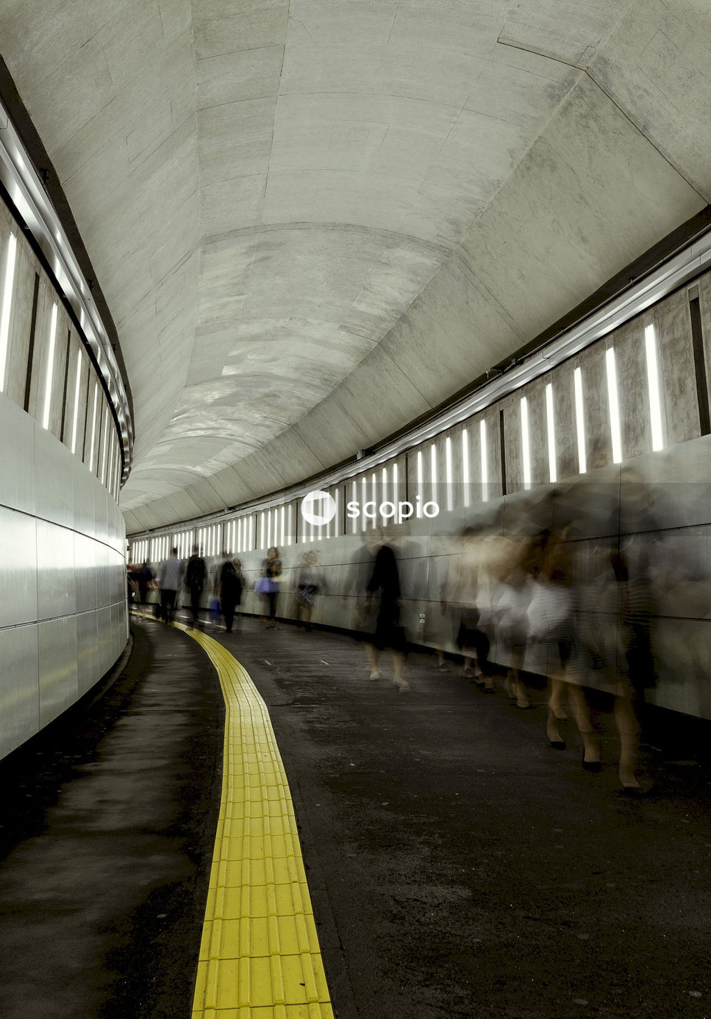 Long shot of people walking on train station