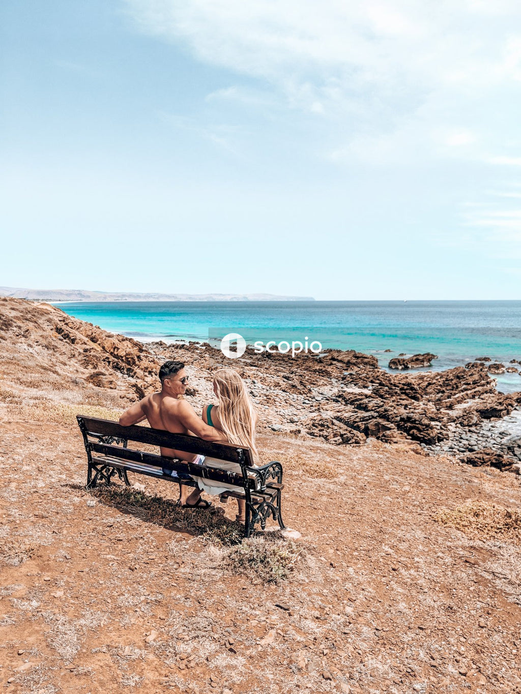 Man and woman sitting on bench on looking at each other