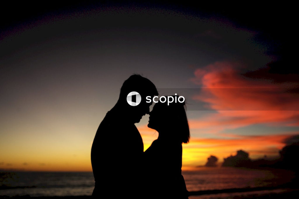 Silhouette of man and woman kissing during sunset