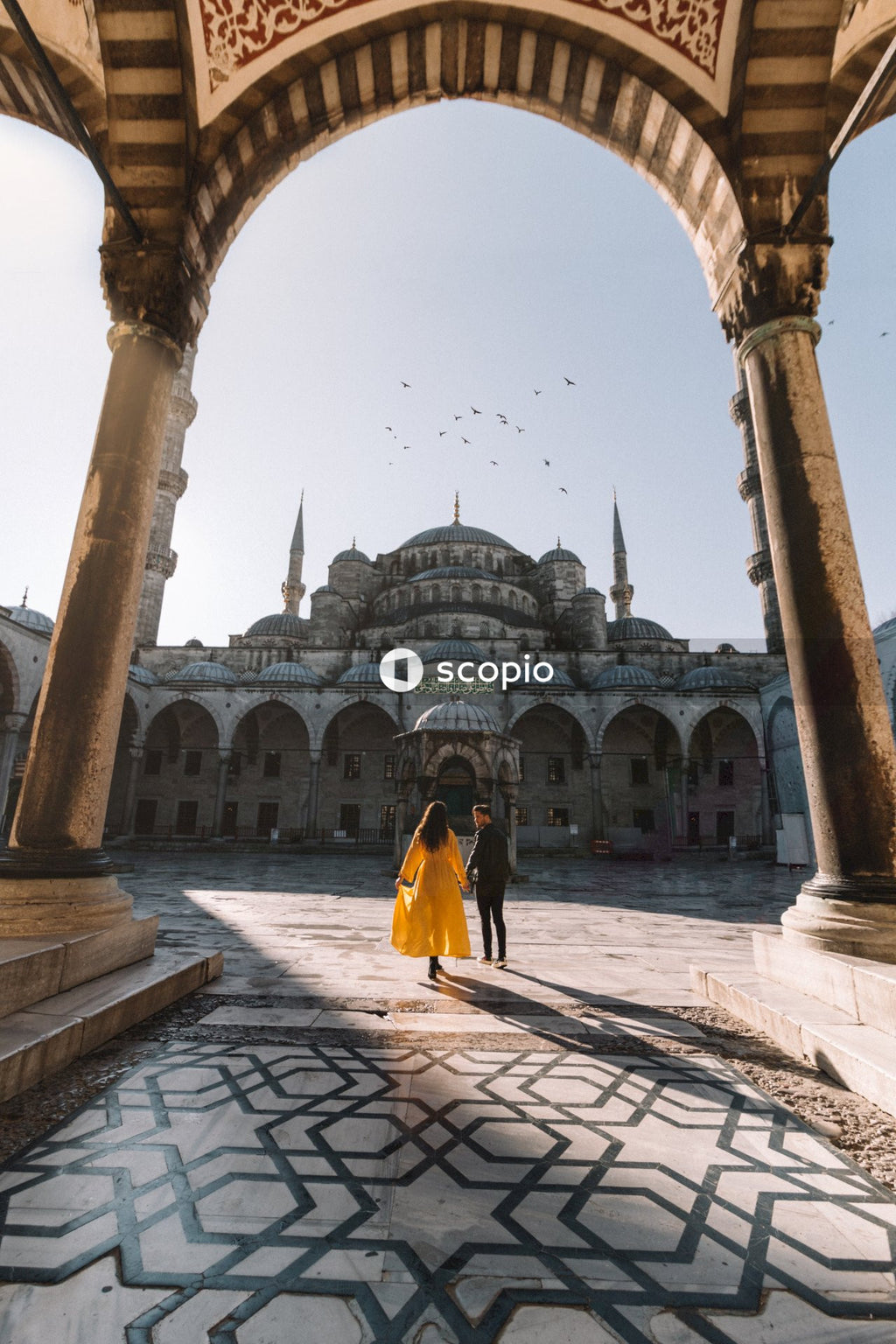 Young couple on a romantic stroll towards the Sultan Ahmed mosque in Istanbul
