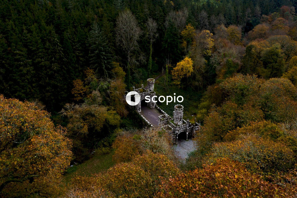Aerial drone view of Ireland's Ballysaggartmore Towers . Medieval bridge in the forest, Lismore, County Waterford.