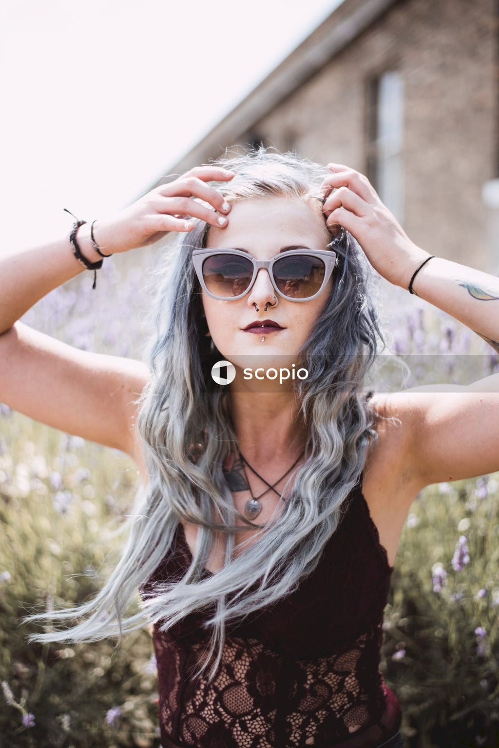 Woman in black tank top wearing black sunglasses