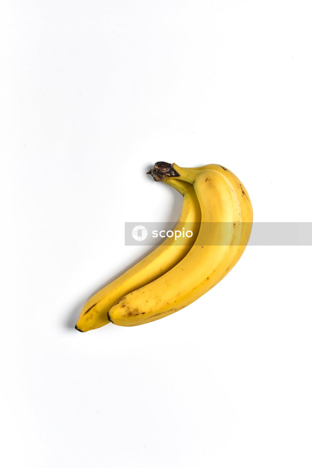 Yellow banana fruit on white surface