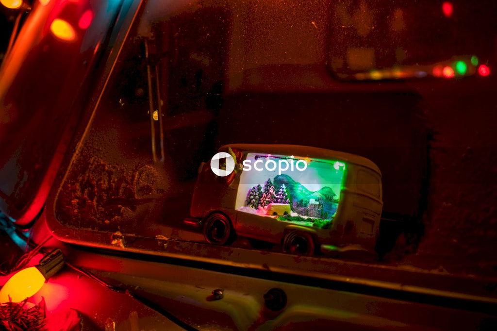Vehicle displaying christmas scene decoration on brown surface