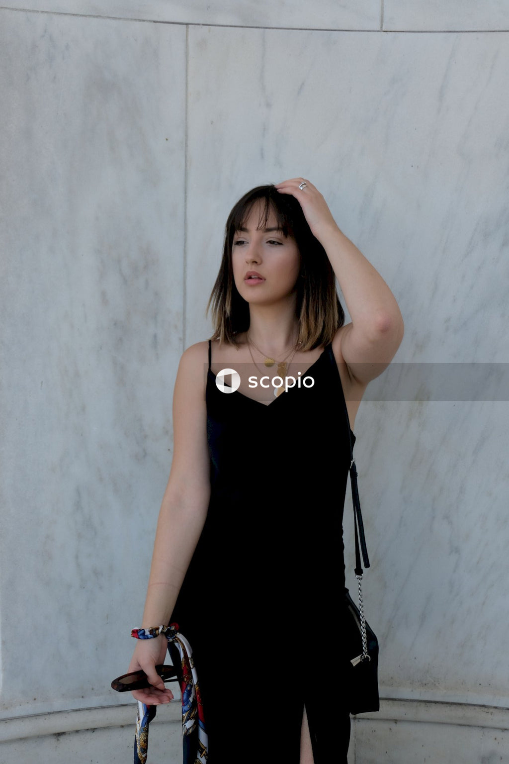 Woman in black tank top standing on white background