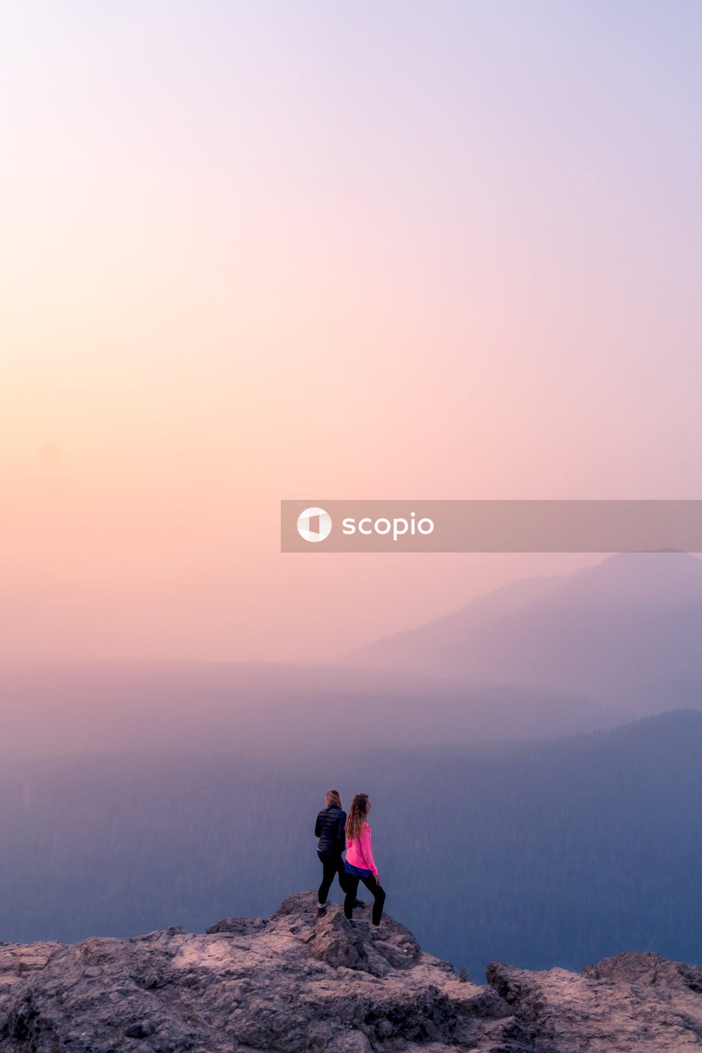 2 person standing on top of mountain