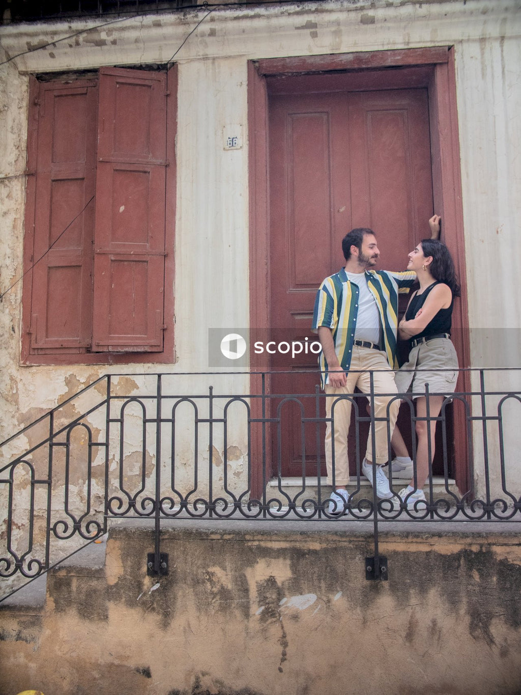 Woman and man standing at door entrance talking