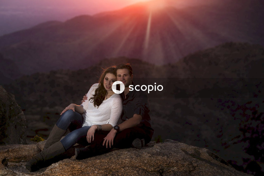 Couple siting on top of mountain