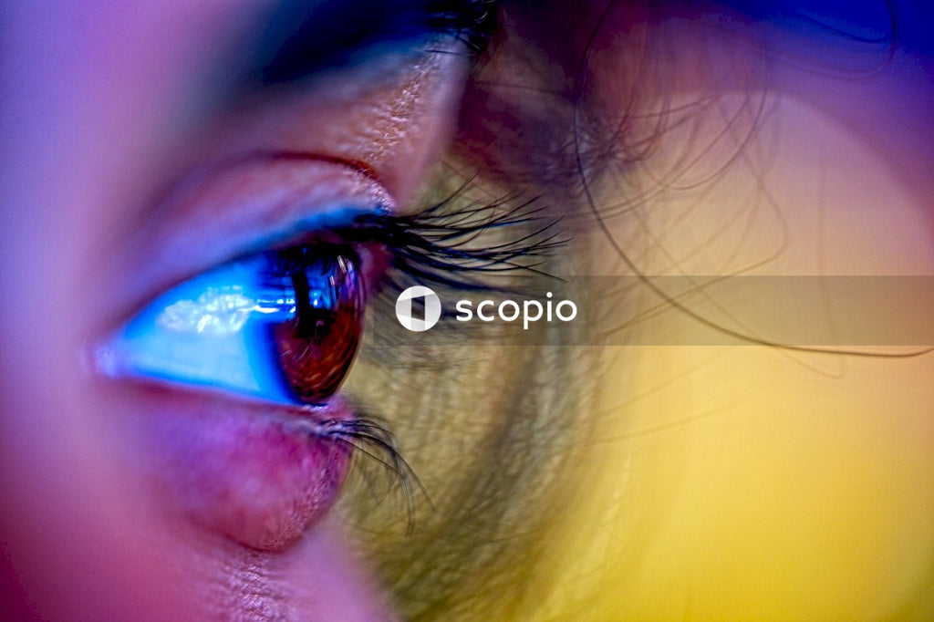 A young Indian girl's brown eye surrounded by hair