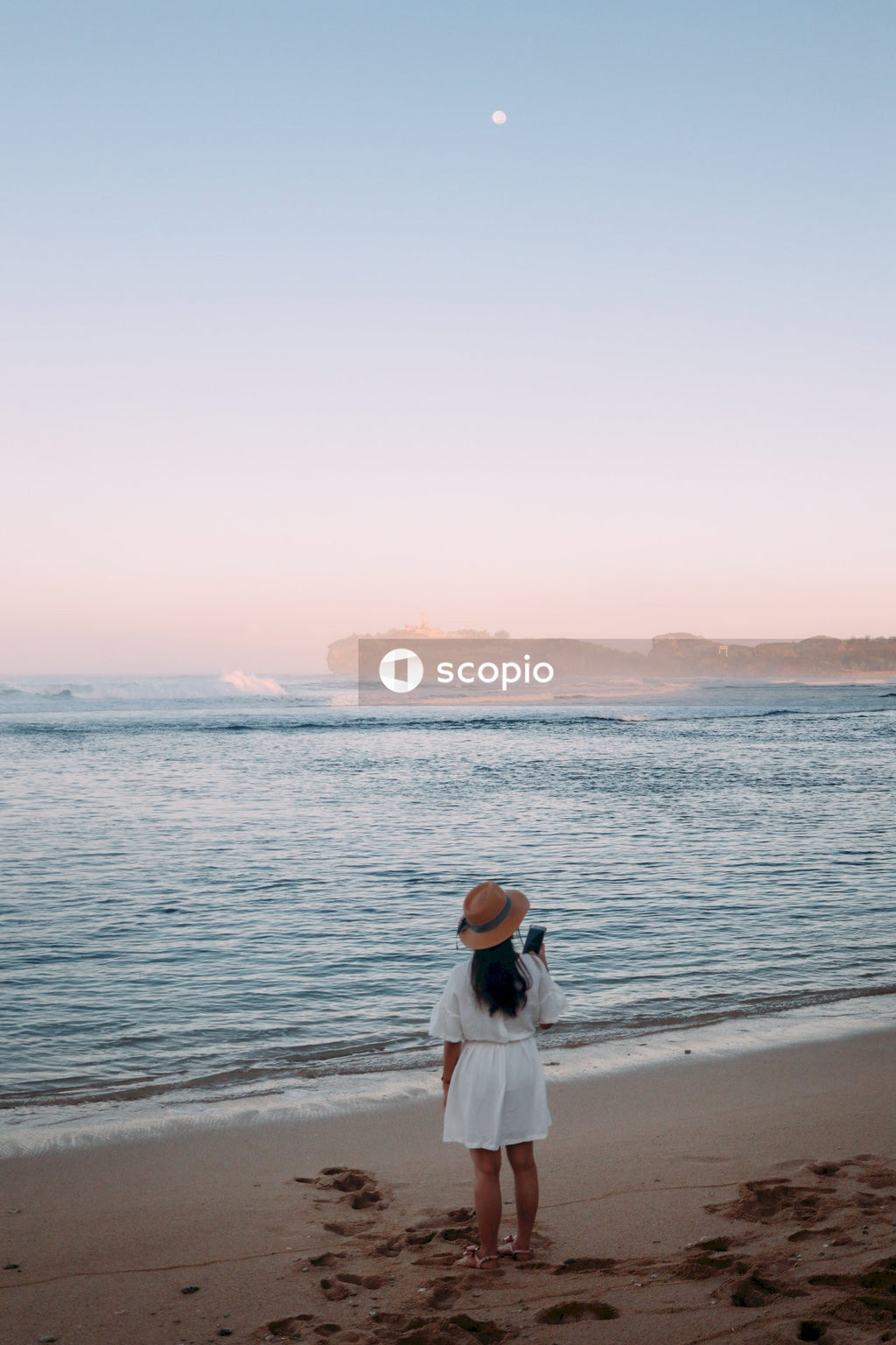 Woman in white dress standing on beach