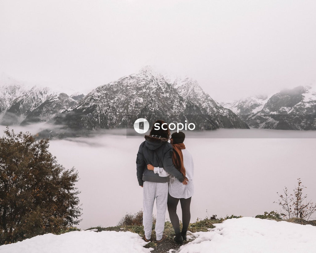 Back view of couple looking at winter landscape