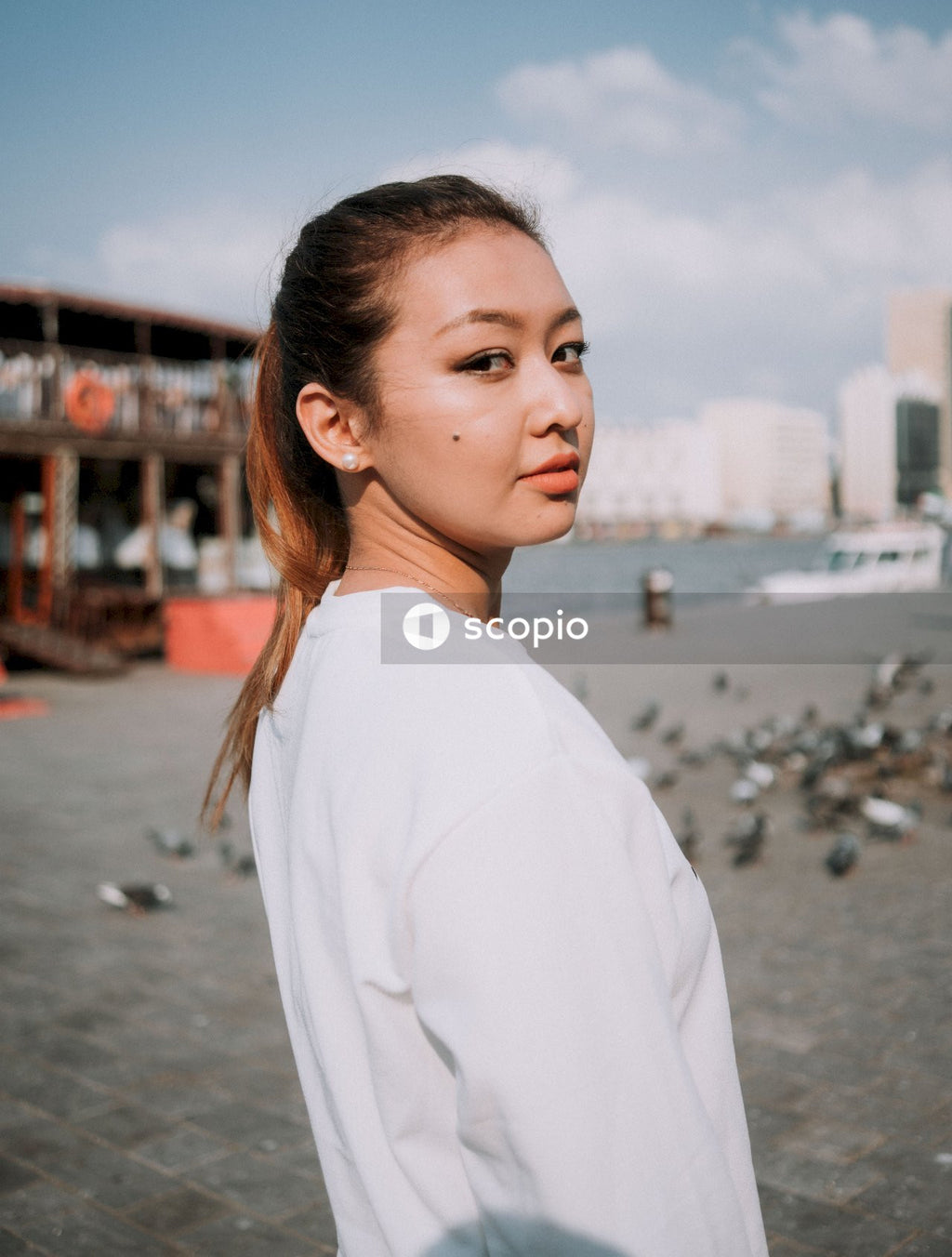 Woman in white long sleeve shirt standing on beach