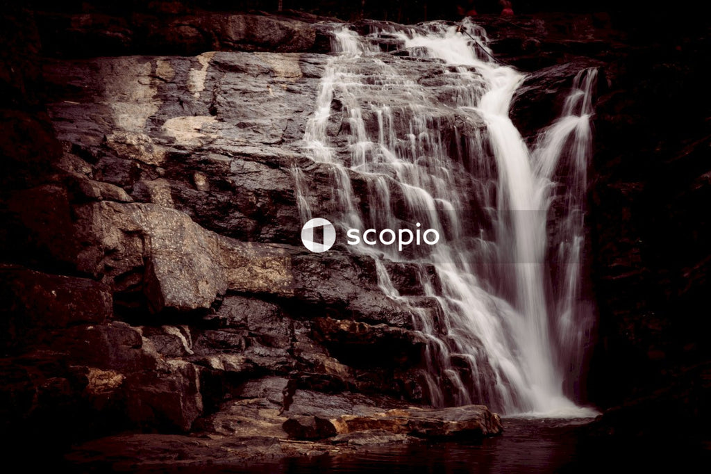 Waterfall on brown rock inside cave