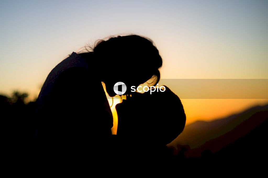 Silhouette of man and woman almost kissing at sunset