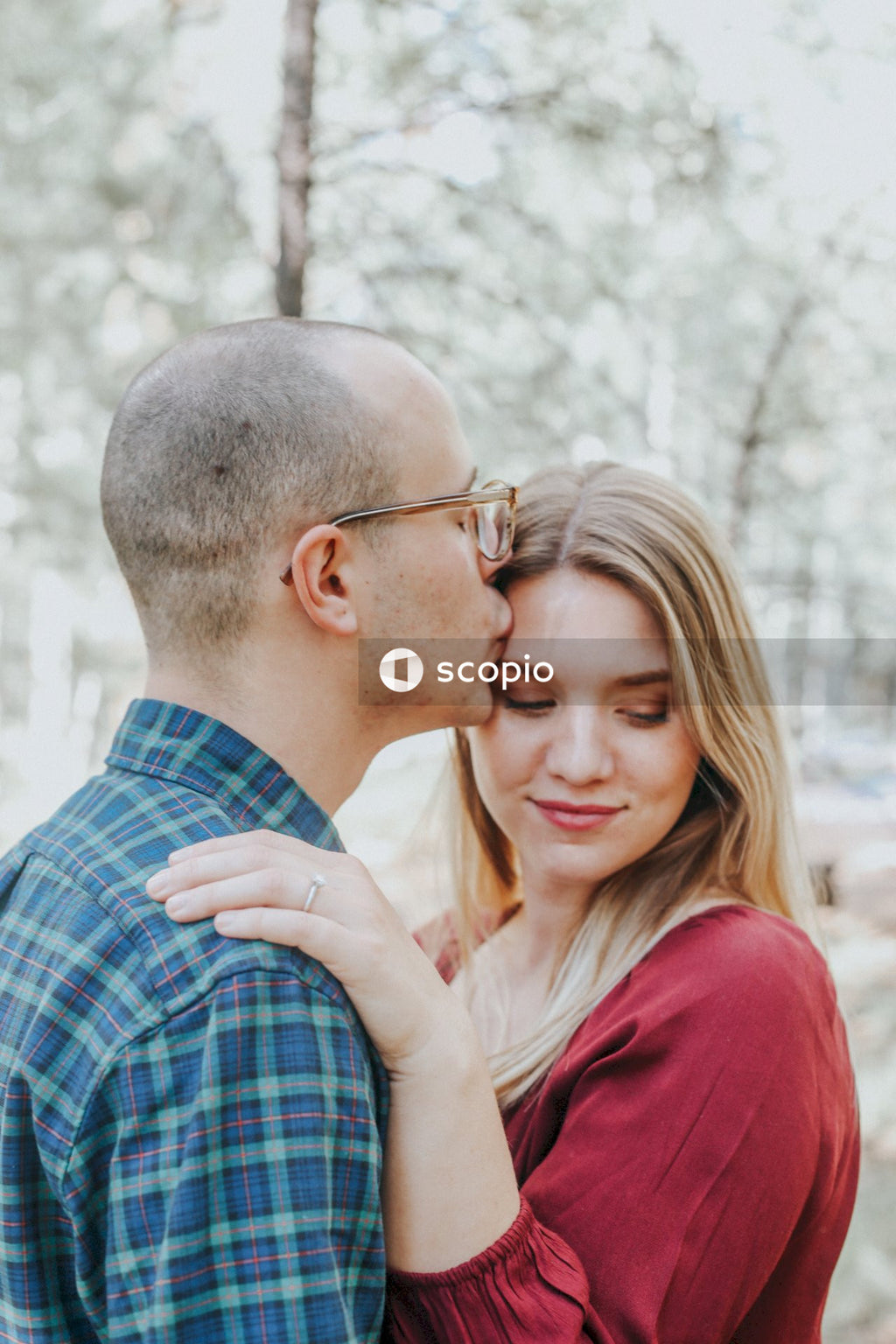 Man kissing woman's forehead