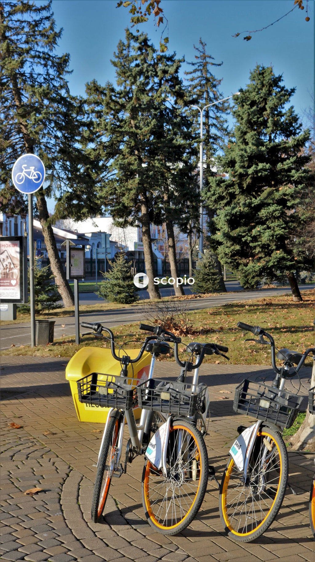 Bicycle parked on sidewalk near trees