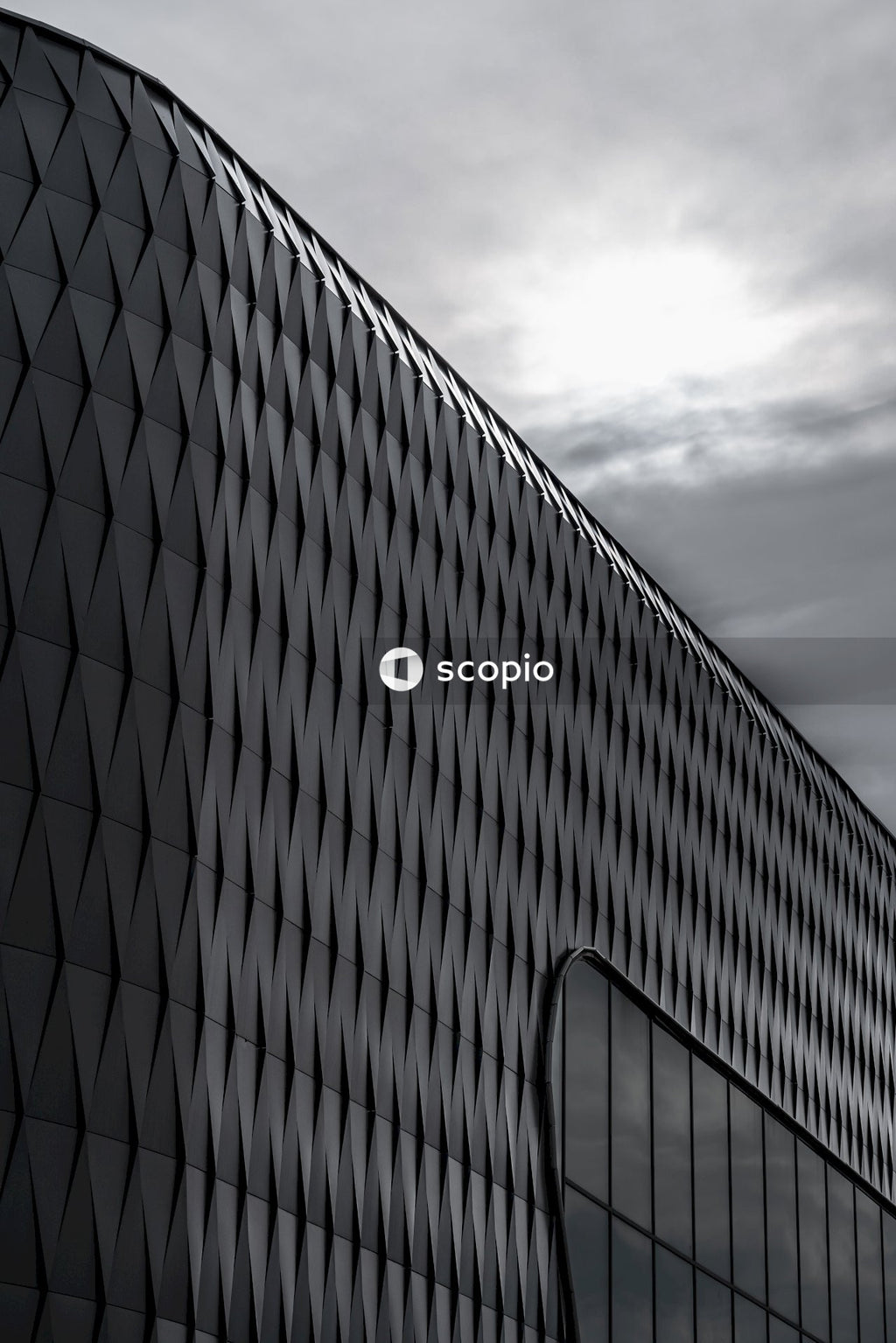 Black and gray building under gray clouds