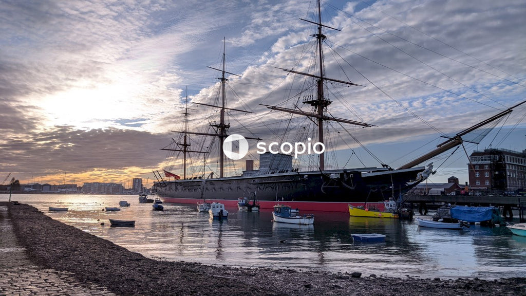 Black and red yacht on a sea shore
