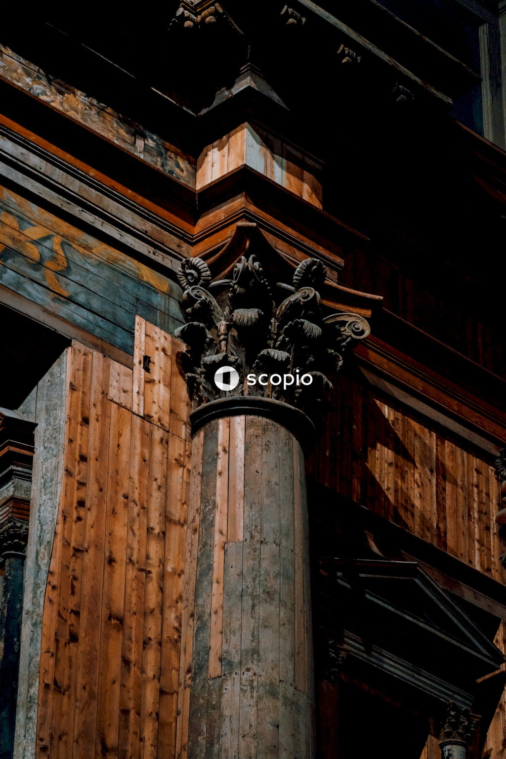 Black lion statue on brown wooden post