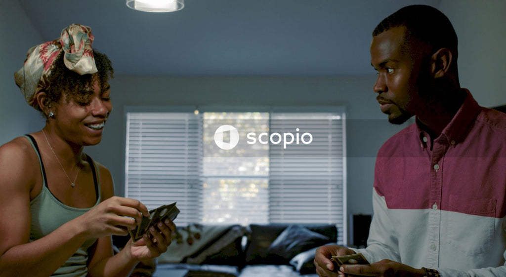Black man and Black woman playing cards indoor
