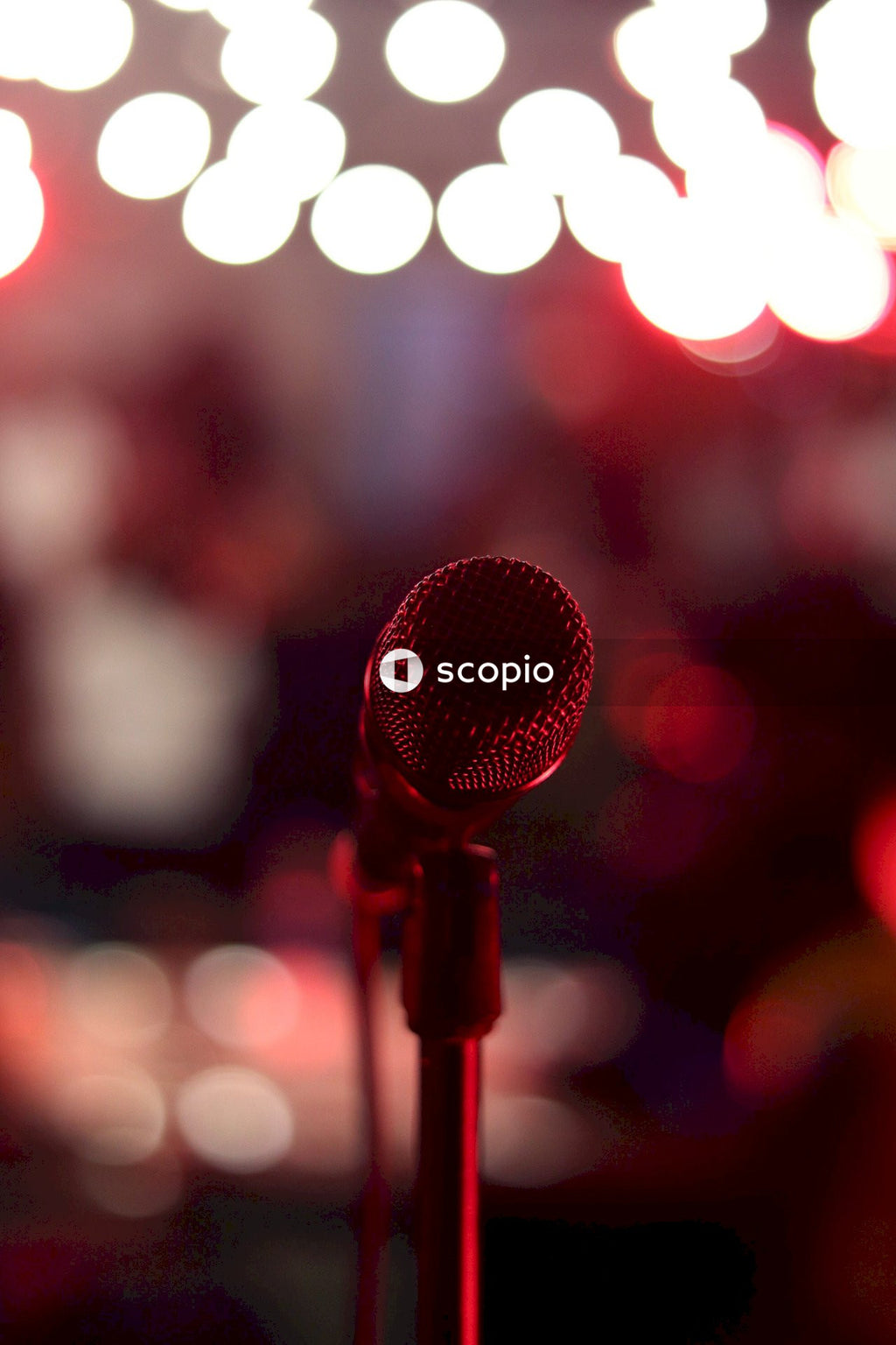 Black microphone with red light bokeh