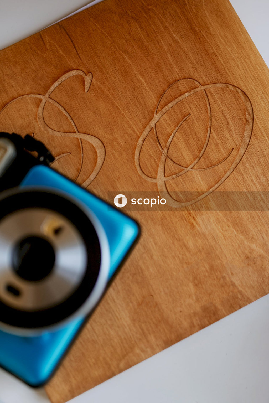 Blue and black device on brown wooden table