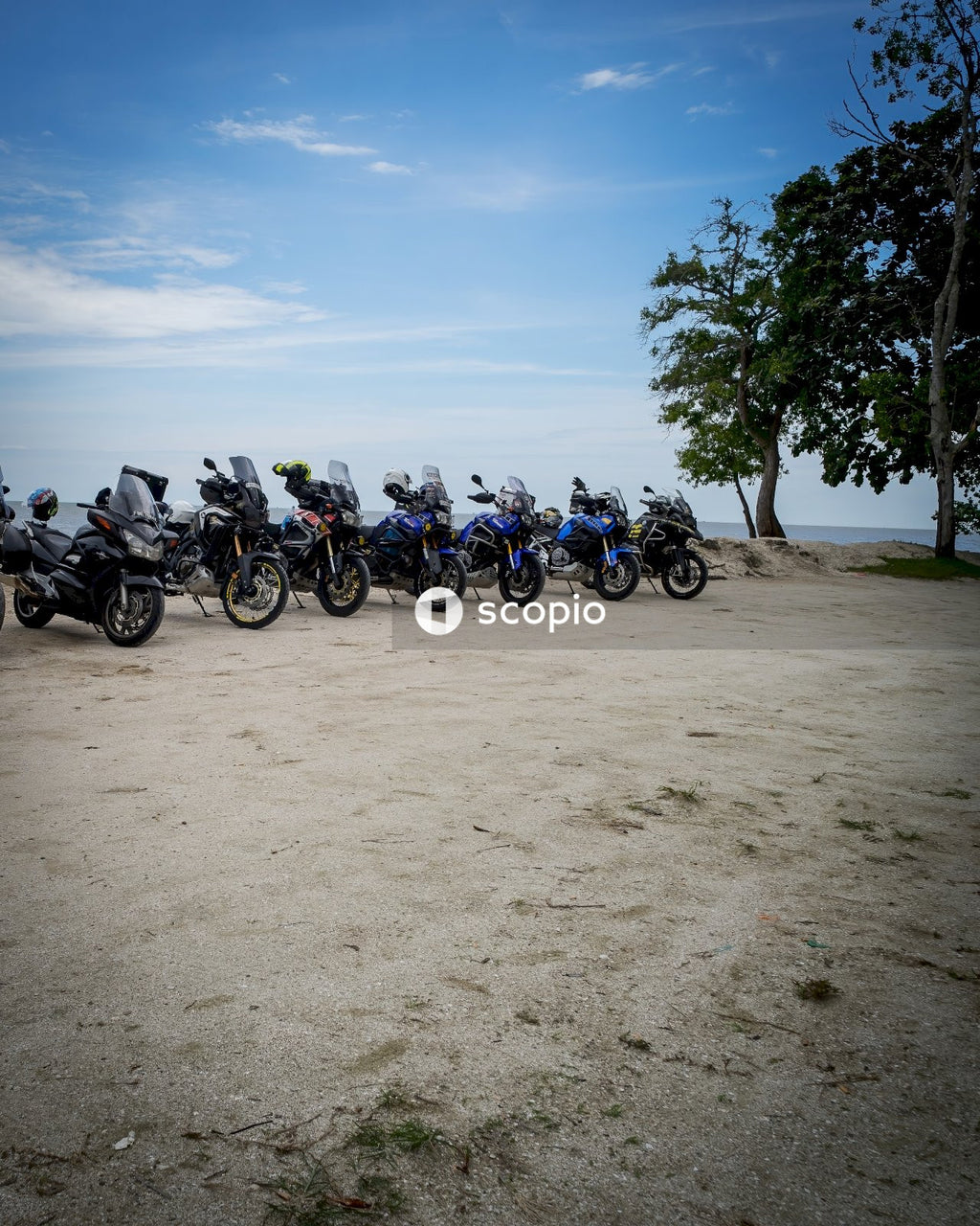 Blue and black motorcycle parked on brown sand