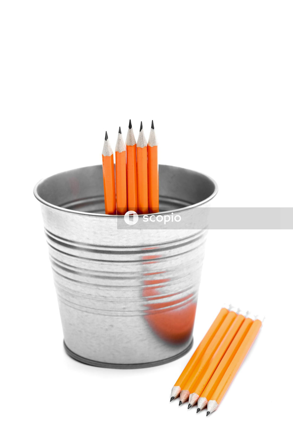 Blue and orange pencils in gray cup