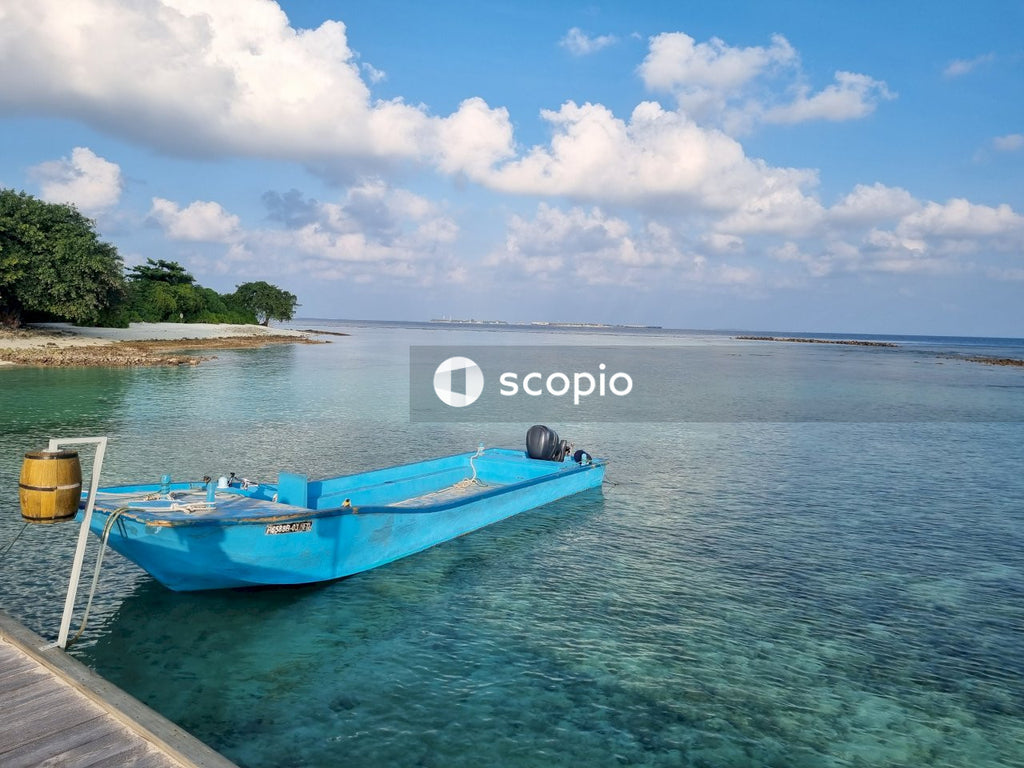 Blue and white boat on sea under blue sky