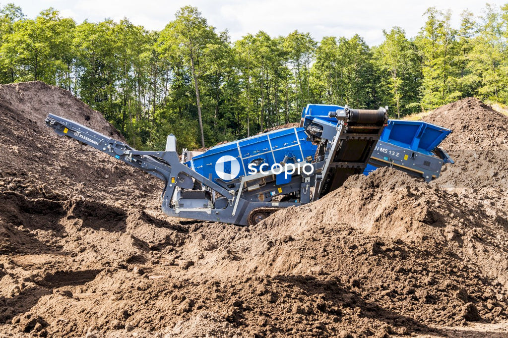 Blue and white heavy equipment on brown sand
