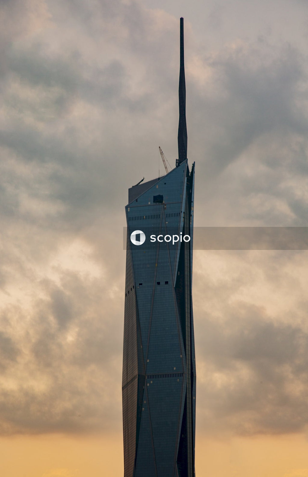 Blue and white tower under cloudy sky