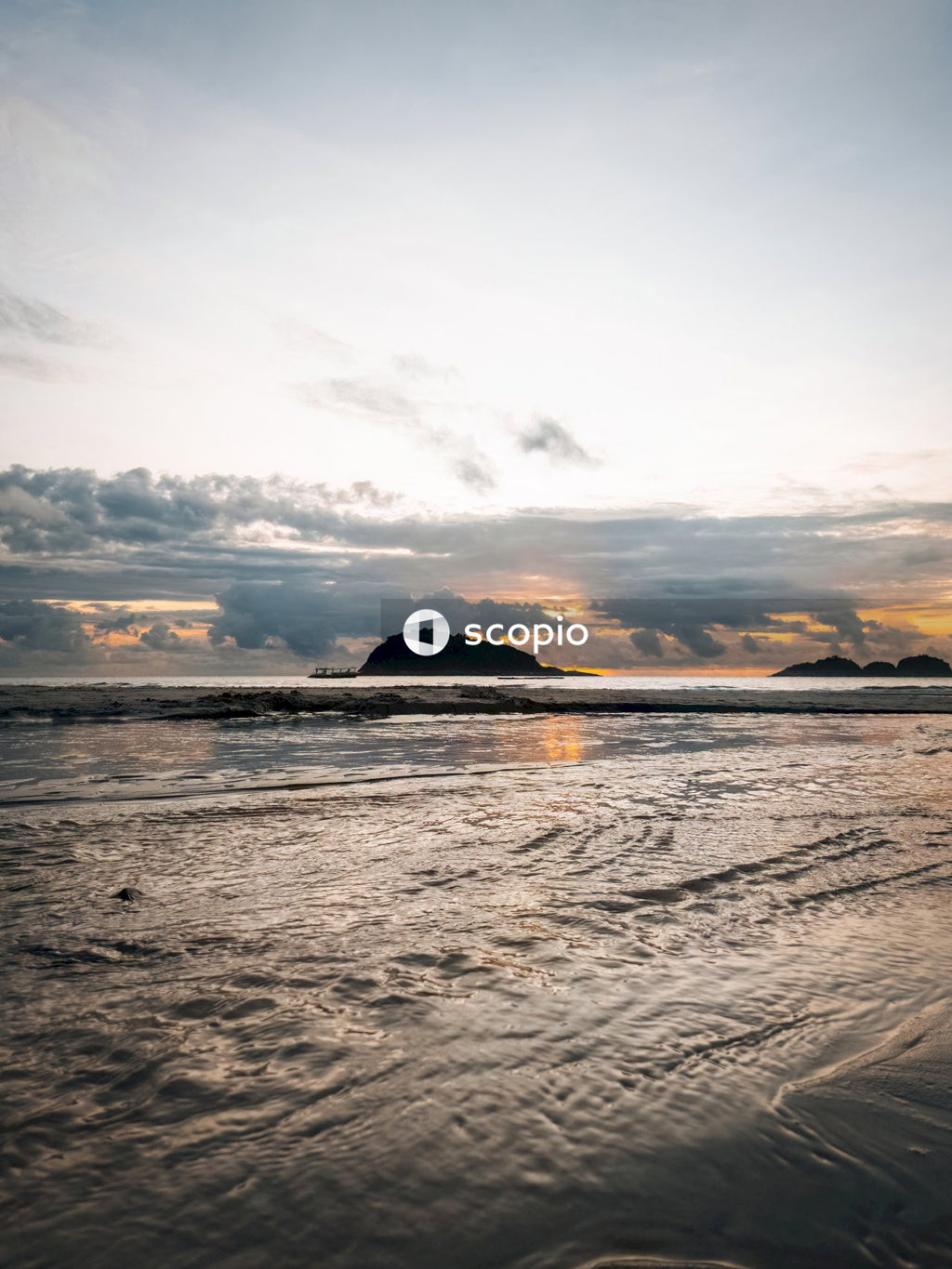 Body of water under cloudy sky during sunset