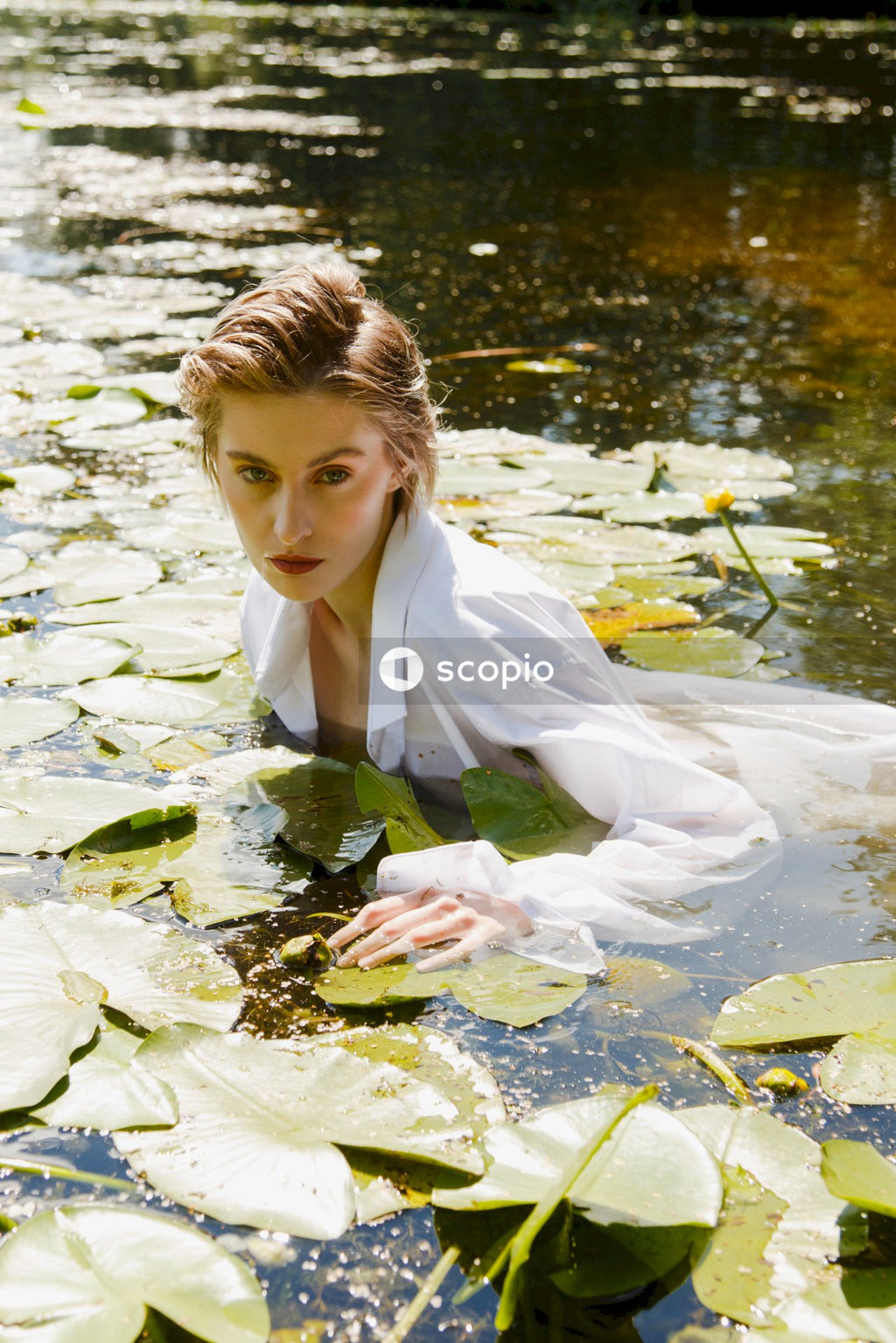 Boy in white dress shirt on water