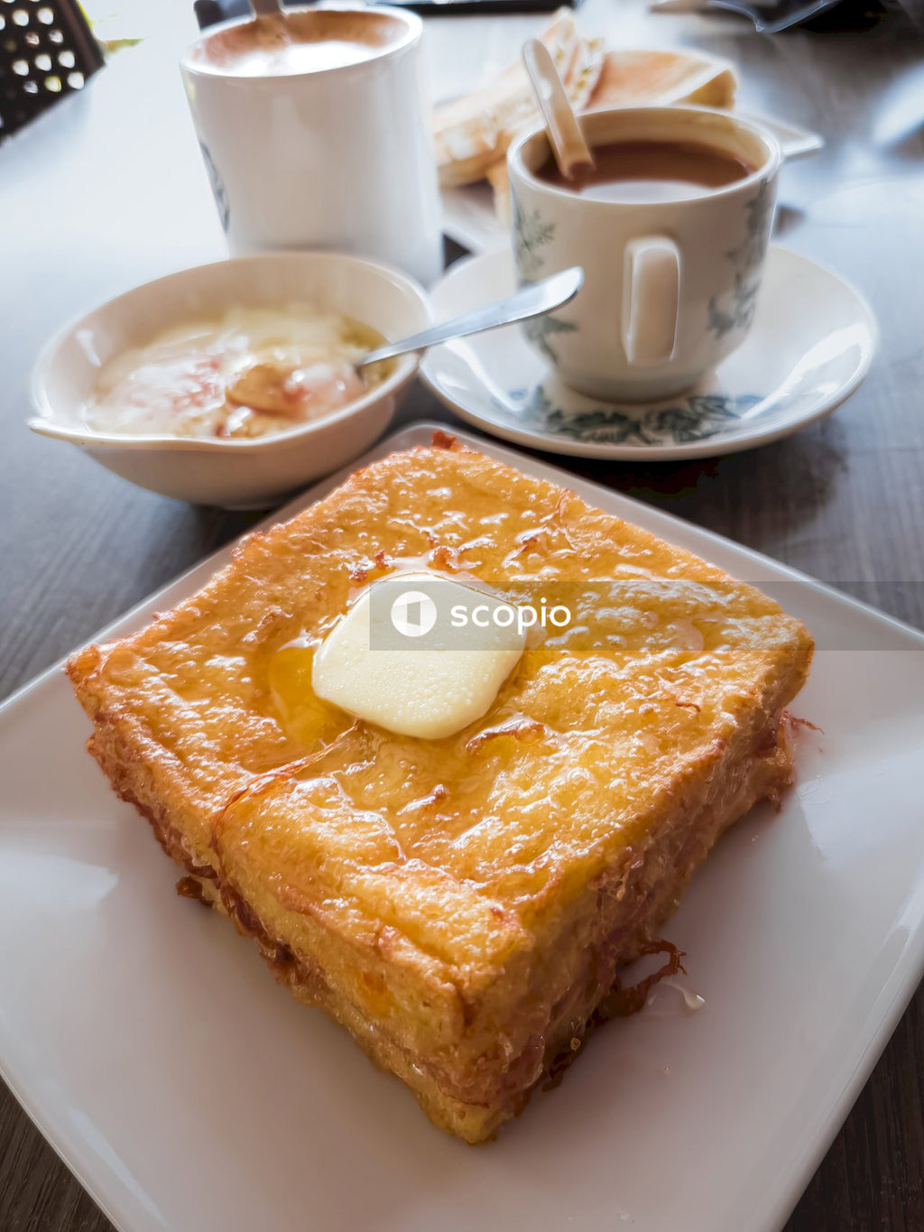 Bread on white ceramic plate beside white ceramic mug